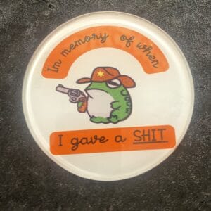 Frog holding gun coaster