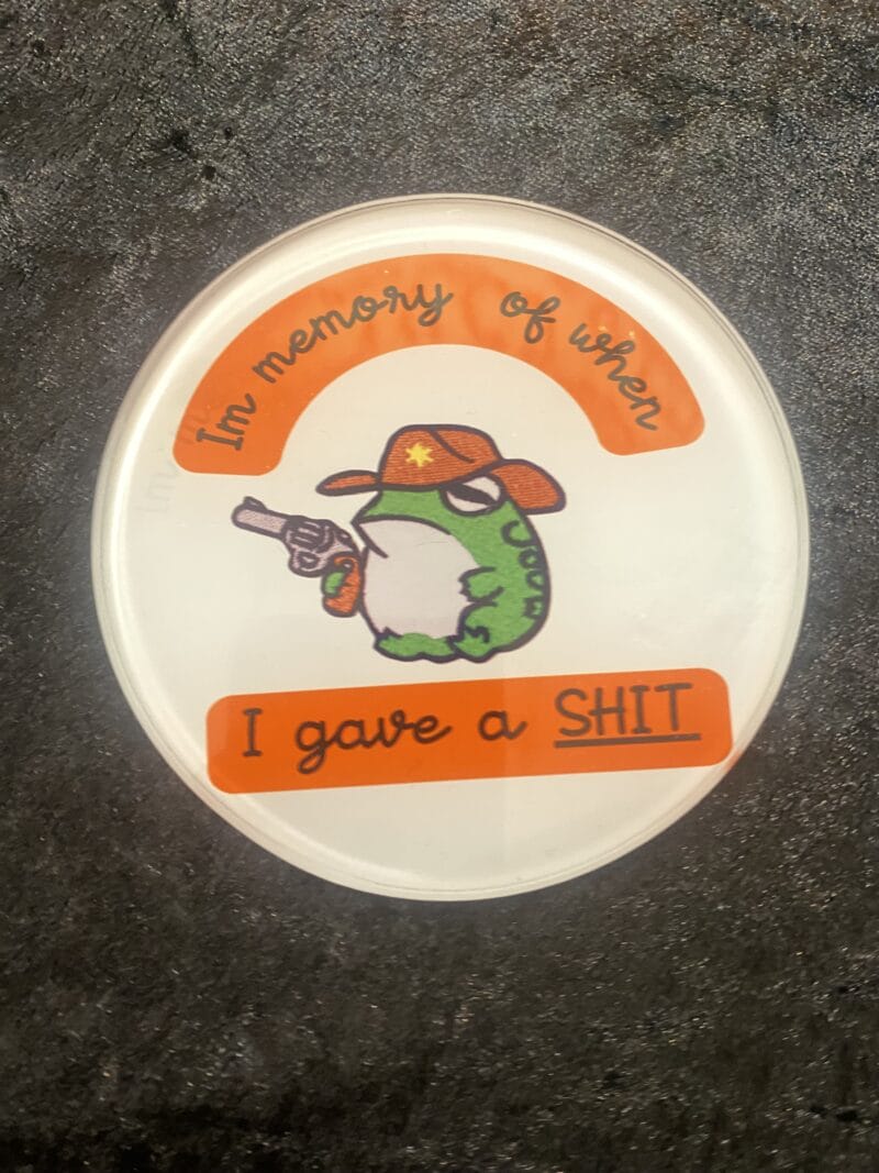 Frog holding gun coaster
